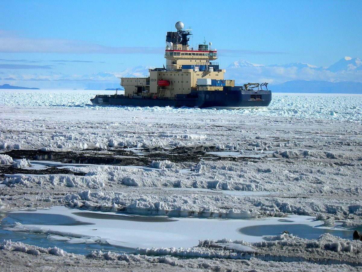 An ice-strengthened ship pushing through Antarctic pack ice