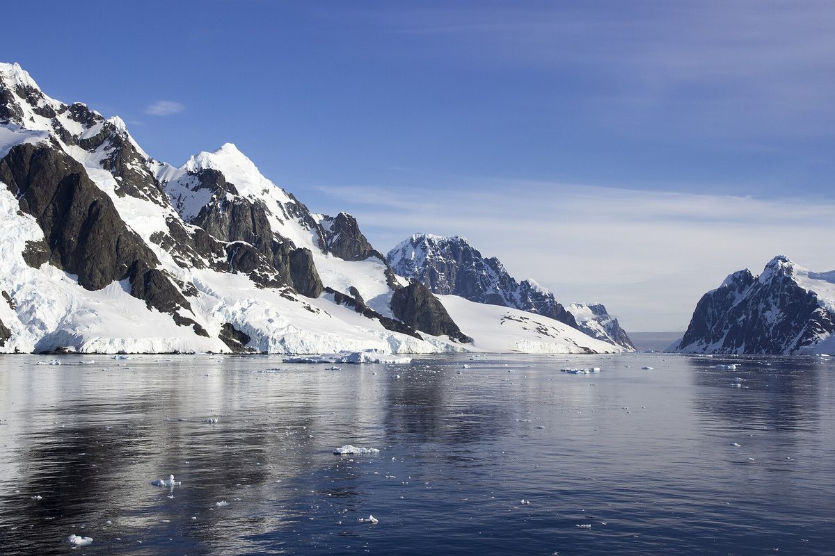 Cruise ship sailing the narrow Lemaire Channel in Antarctica