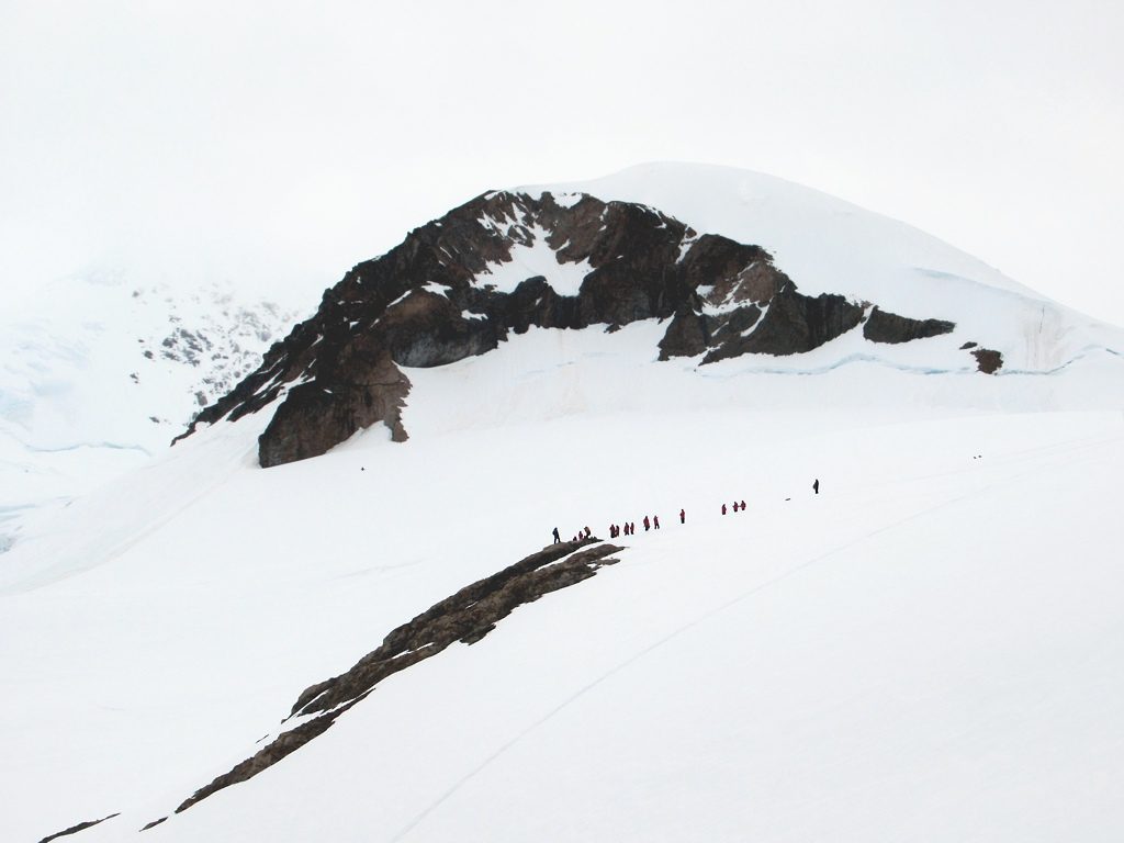 Travelers walking ashore on an Antarctic landing