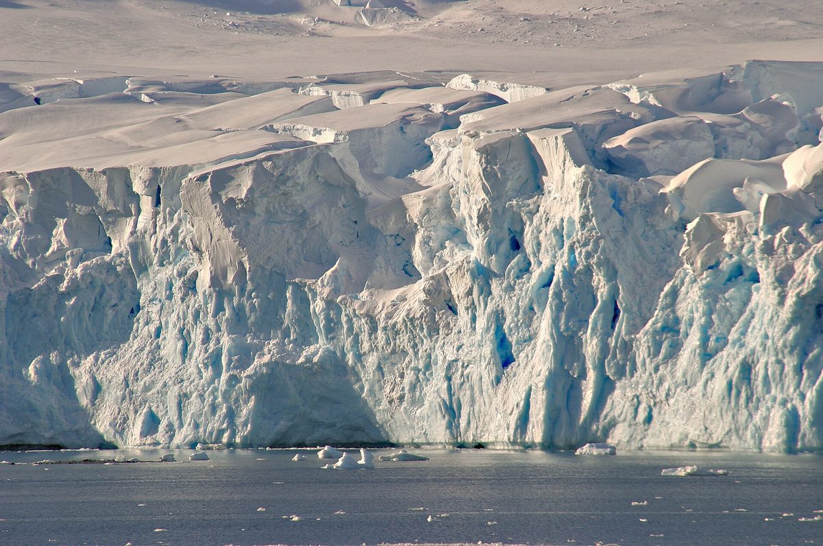 Snow mountains rising above the narrow Lemaire Channel in Antarctica