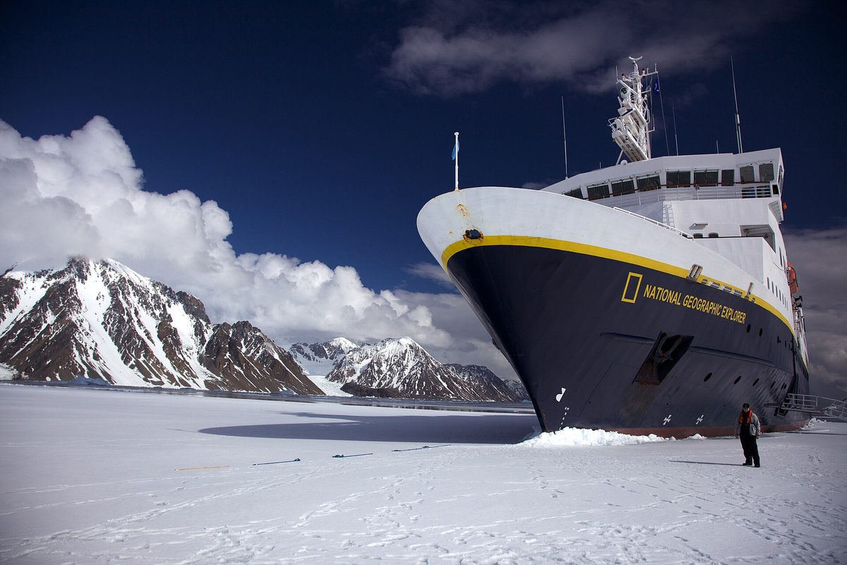 An expedition ship bow-first in Antarctic fast ice